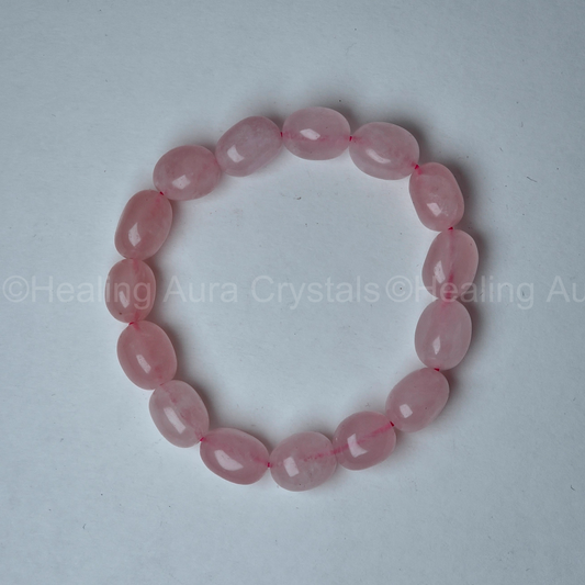 Pink beaded bracelet on a light gray background with 'Healing Aura Crystals' branding.