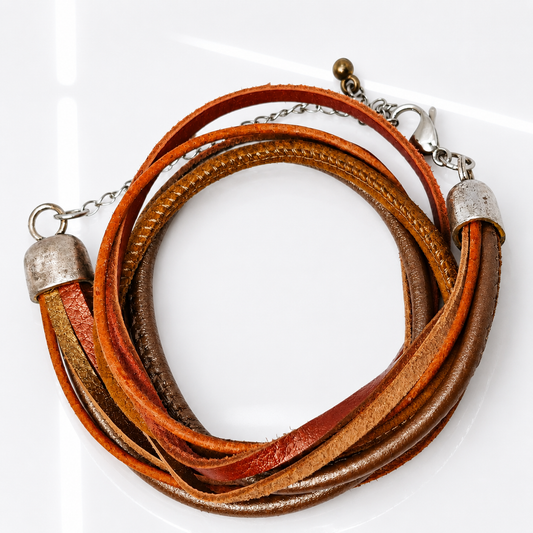 A multi-strand wrap bracelet made of layered leather cords in warm brown, rust orange, and tan tones, finished with silver-tone metal caps and chain clasp on a white background.