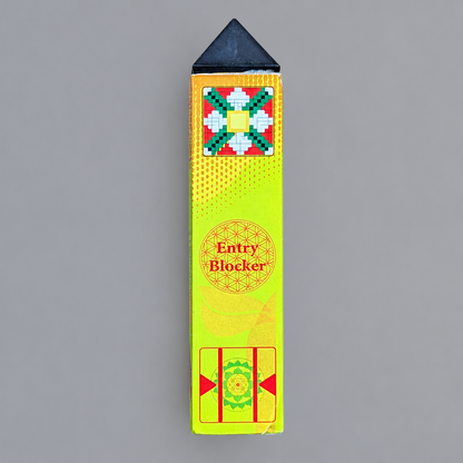A rectangular yellow and green entry blocker with a black triangular tip, shown on a plain gray background. The box features red and green geometric designs and the text 'Entry Blocker'.
