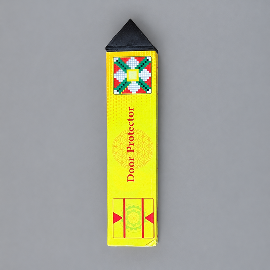 A yellow rectangular door protector with a black triangular tip, shown on a plain gray background. The yellow cover has red text reading 'Door Protector' and decorative geometric graphics.