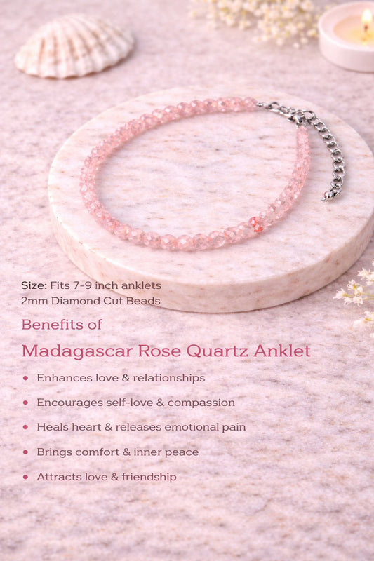 Pink beaded anklet on a stone surface with shell and candle in the background