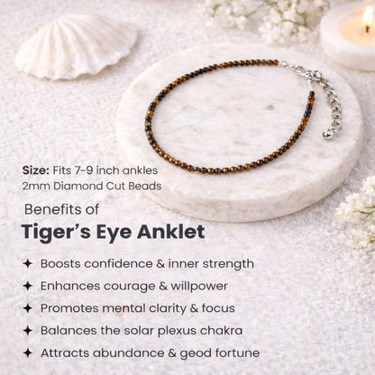 Tiger's Eye anklet on a marble surface with text about benefits and size information.