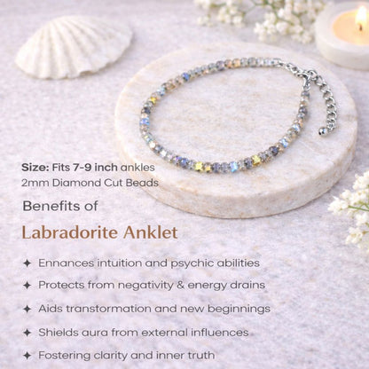 Labradorite anklet on a marble surface with shell and candle in the background