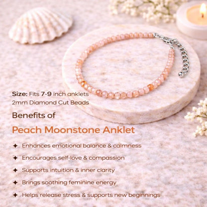 Peach Moonstone anklet on a stone surface with shell and candle in the background