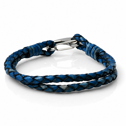 A braided leather bracelet in shades of blue and black, featuring a silver-toned metal spring ring clasp, shown on a white reflective background.