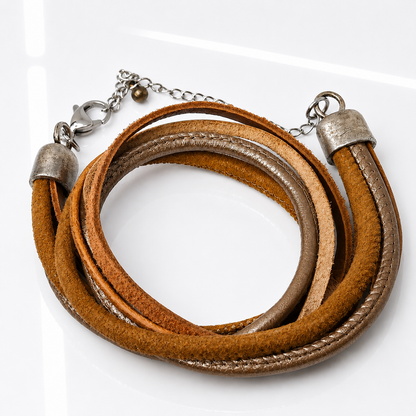 A multi-strand wrap bracelet made of brown suede and smooth leather strips, accented with silver-tone metal caps, chain, and clasp, shown on a white background.