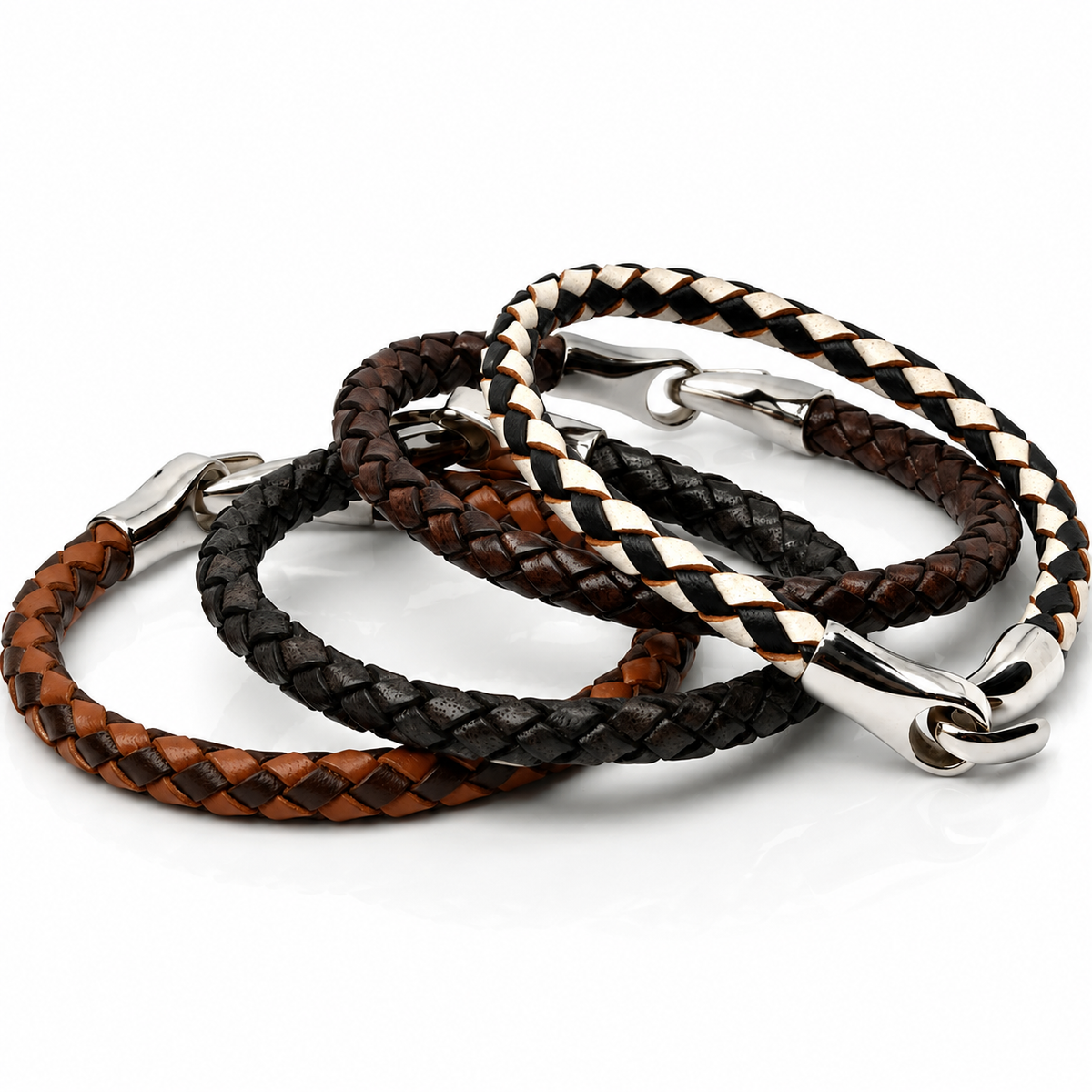 Three braided leather bracelets in brown, black, and white, each with a silver metal clasp, arranged on a white background.