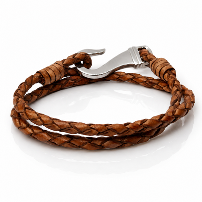 A brown braided leather wrap bracelet with a polished silver-toned metal lobster clasp, displayed on a clean white background.