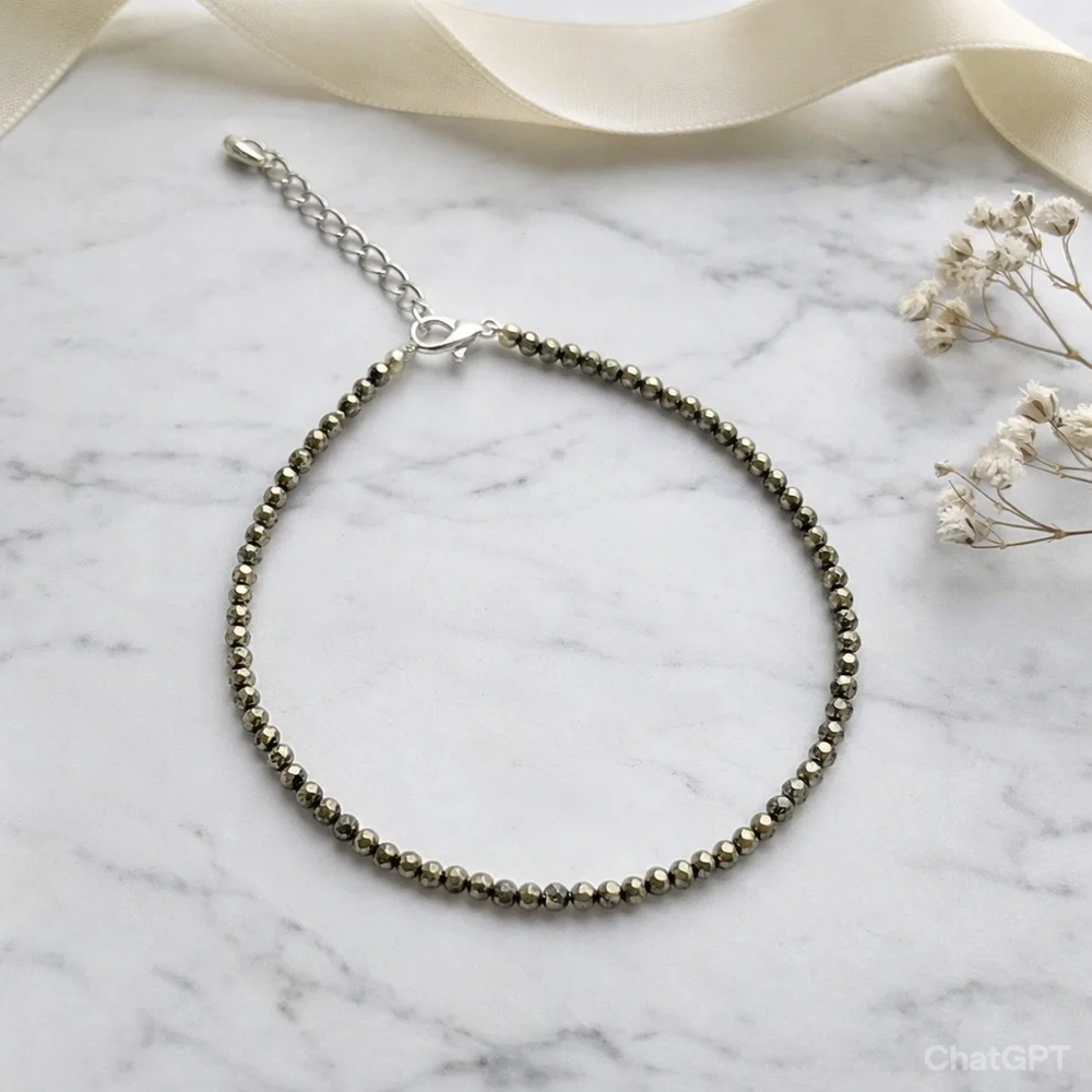 Beaded bracelet on a marble surface with delicate flowers